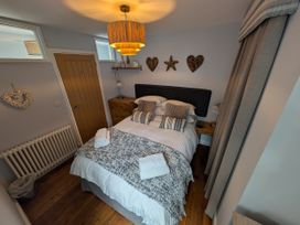 A bedroom with a bed and decorative items at Seaside in Lyme Regis