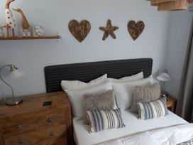 A bedroom with a bed and decorative items at Seaside in Lyme Regis