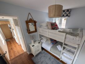 A bedroom with a bunk bed and a nightstand at Seaside in Lyme Regis