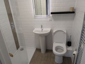 A bathroom with a shower, sink, and toilet at Seaside in Lyme Regis