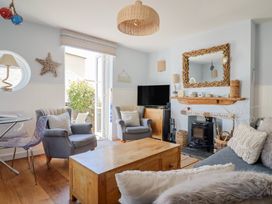 A living room with a fireplace and television at Seaside in Lyme Regis