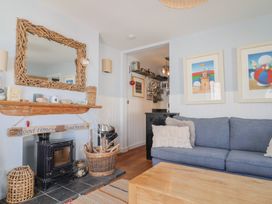 A living room with a fireplace and couch at Seaside in Lyme Regis