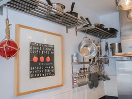 A kitchen with cooking utensils and framed art at Seaside in Lyme Regis