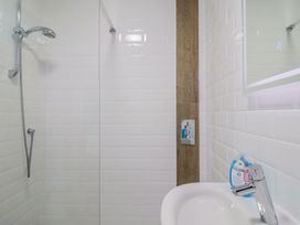 A bathroom with a shower and sink at Seaside in Lyme Regis