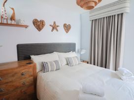 A bedroom with a bed and decorative items at Seaside in Lyme Regis