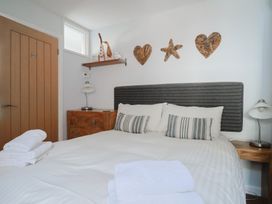 A bedroom with a bed and bedside table at Seaside in Lyme Regis