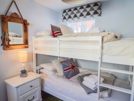 A bedroom with a bunk bed and a nightstand at Seaside in Lyme Regis