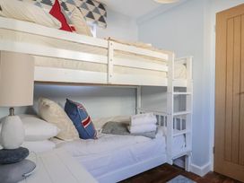 A bedroom with a bunk bed and pillows at Seaside in Lyme Regis