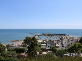 A view of the beach and harbor at Seaside in Lyme Regis
