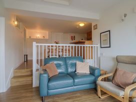 A living room with a sofa and armchair at Greystones Flat in Lyme Regis
