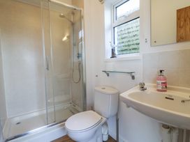 A bathroom featuring a shower, toilet, and sink at Greystones Flat in Lyme Regis