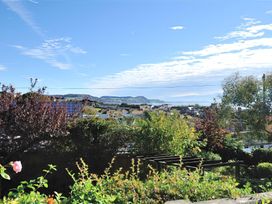 A view of the landscape with trees and buildings at Greystones Flat in Lyme Regis