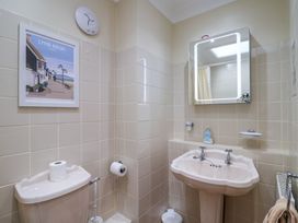 A bathroom with a toilet and sink at Blacksmiths Cottage Lyme Regis