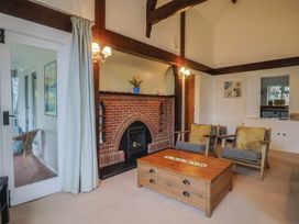 A living room with a fireplace and seating at Maries in Lyme Regis