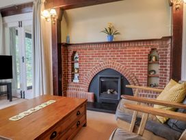 A living room with a fireplace and TV at Maries in Lyme Regis
