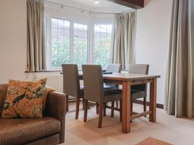 A dining room with a table and chairs at Maries in Lyme Regis