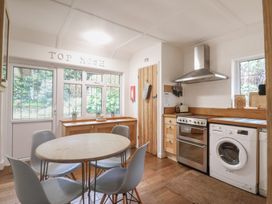 A kitchen with a table and chairs at Top Kosh in Lyme Regis