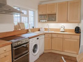 A kitchen with appliances and cabinets at Maries in Lyme Regis