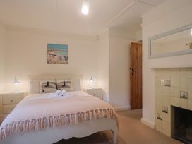 A bedroom with a bed and bedside tables at Maries in Lyme Regis