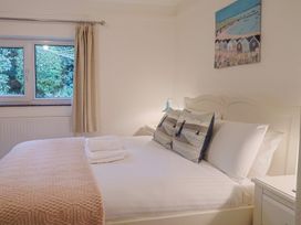 A bedroom with a bed and window at Maries Lyme Regis