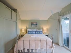 A bedroom with a bed and nightstands at Maries in Lyme Regis