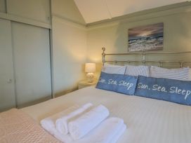 A bedroom with a bed and bedside table at Maries in Lyme Regis