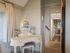 A hallway with a vanity and mirror at Maries in Lyme Regis