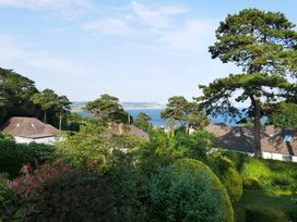 A view of the sea and trees from an outdoor area at Maries in Lyme Regis