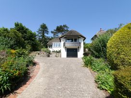 A house with a thatched roof and garden at Maries in Lyme Regis