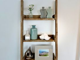 A shelf with vases and a photo frame at 11 The Gables Lyme Regis