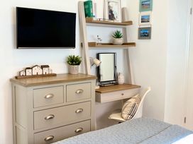 A bedroom with a desk and shelves at 11 The Gables in Lyme Regis
