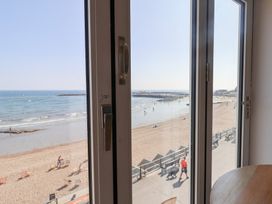 A view of the beach and sea from a window at Seagull in Lyme Regis