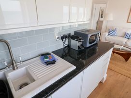 A kitchen with a sink and microwave at Seagull in Lyme Regis