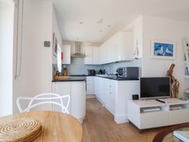 A kitchen with appliances and seating at Seagull in Lyme Regis