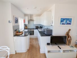 A kitchen with cabinets, oven, and microwave at Seagull in Lyme Regis