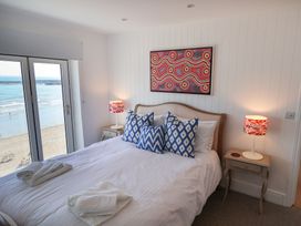 A bedroom with a bed and lamps at Seagull in Lyme Regis