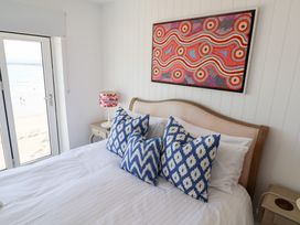 A bedroom with a bed and window view at Seagull Lyme Regis