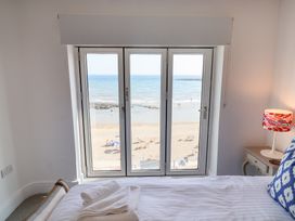 A bedroom with a view of the beach at Seagull in Lyme Regis