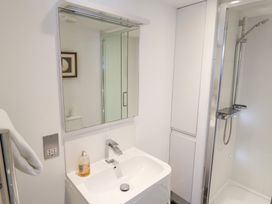 A bathroom with a sink and shower at Seagull in Lyme Regis