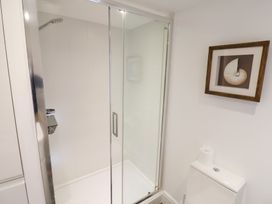 A bathroom with a shower and toilet at Seagull in Lyme Regis