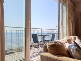 A living room with a view of the ocean at Watersmeet in Lyme Regis