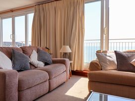 A living room with a sofa and lamp at Watersmeet in Lyme Regis