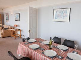 A dining room with a table set for dinner at Watersmeet in Lyme Regis