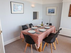 A dining room with a table set for dinner at Watersmeet in Lyme Regis