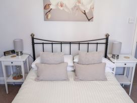 A bedroom with a bed and bedside tables at Watersmeet in Lyme Regis