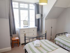 A bedroom with two beds and a chest of drawers at Watersmeet in Lyme Regis
