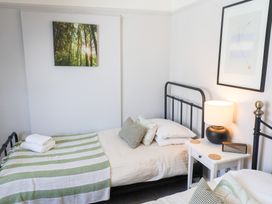 A bedroom with beds and a lamp at Watersmeet in Lyme Regis