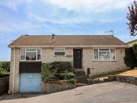 A house with a garage and landscaping at Gosling Way Lyme Regis