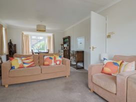 A living room with sofas and a window at Gosling Way in Lyme Regis