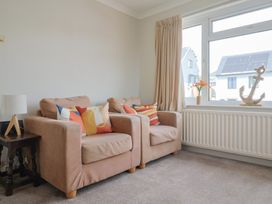 A living room with two sofas and a window at Gosling Way in Lyme Regis